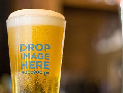 Label Mockup Featuring a Beer Glass at a Table