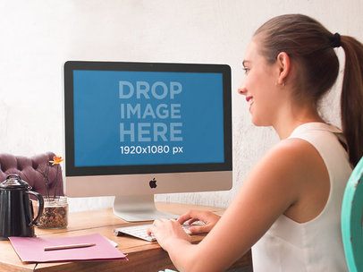 iMac Mockup Template of a Young Woman at a Creative Studio