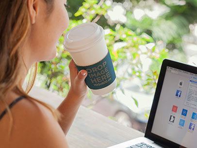 Takeaway Coffee Cup Mockup of a Woman Working on a Macbook