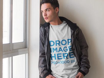 T-Shirt Mockup of a Young Man Looking Out the Window