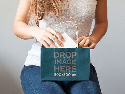 Paper Bag Mockup Featuring a Woman Opening a Gift
