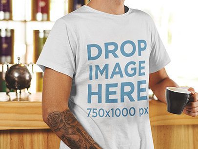 T-Shirt Mockup of a Young Man Holding a Cup of Coffee 1061a