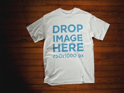 Mockup Template of a T-Shirt Lying Over a Wooden Surface