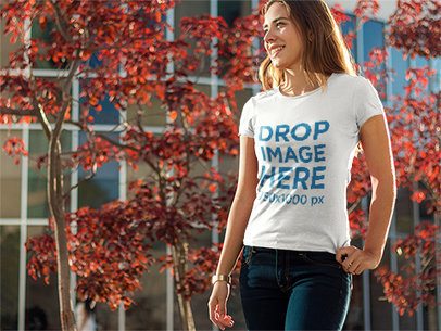T-Shirt Mockup of a Woman Taking a Stroll Around Town