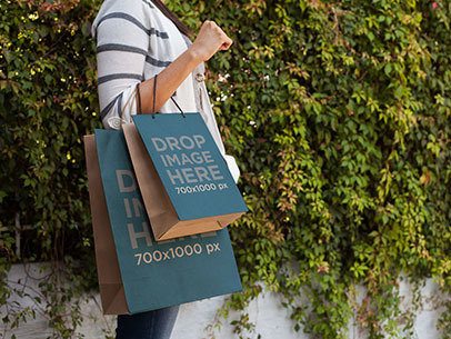 Paper Bag Mockup of a Woman Carrying Two Shopping Bags 