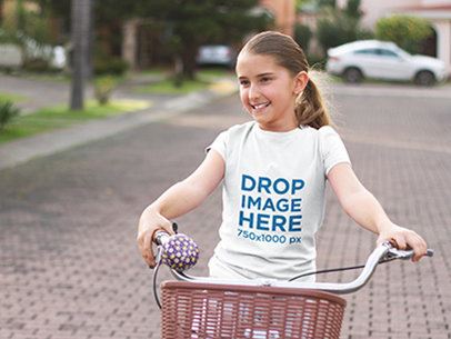 T-Shirt Mockup Featuring a Young Girl Riding a Bicycle