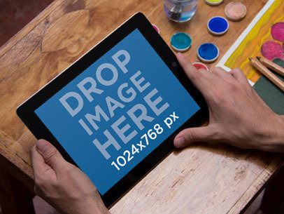 iPad Mockup Featuring Watercolor Paints in the Background