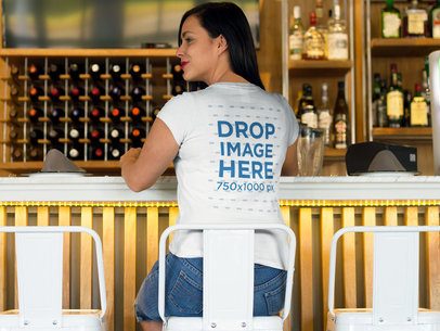 Back Shot of a Woman Sitting at a Bar T-Shirt Mockup