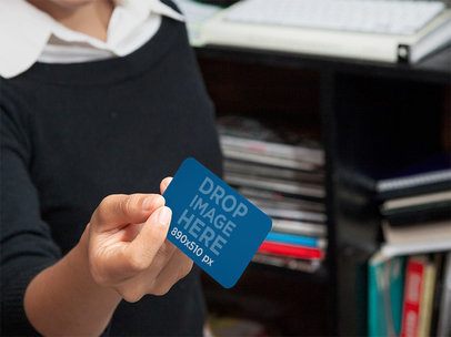 Business Card Held by Woman in Office