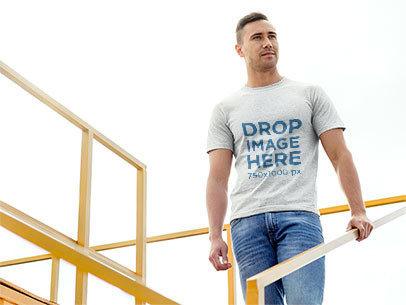 Man Standing on Sports Stadium Bleachers T-Shirt Mockup