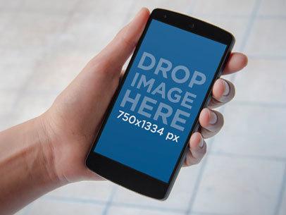 Mockup of a Man Holding a Nexus 5