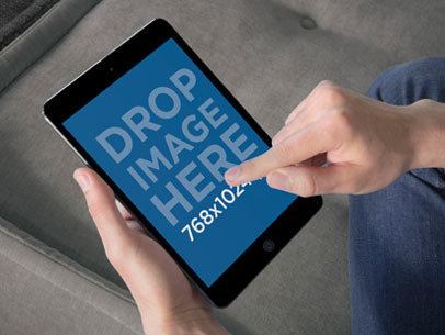 Mockup of a Man Using an iPad in Portrait Position