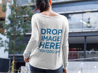 Mockup of a Woman Wearing a Long Sleeve Tee While on the Street