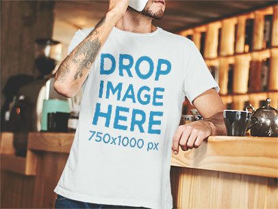 T-Shirt Mockup of a Man Leaning Against a Coffee Bar Counter a1060