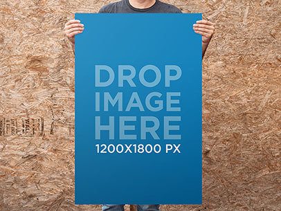Guy Standing in Front of a Wooden Wall Holding a Poster Mockup