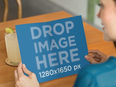 Brochure Mockup of a Woman at a Cafe Looking at a Menu a10312