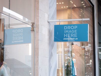 Banner Mockup Hanging From a Wall Outside a Boutique