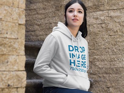 Hoodie Mockup of a Woman Sitting on a Stone Staircase