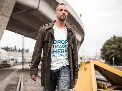 T-Shirt Mockup of a Man Walking Along a Railway