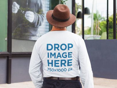 Man Wearing a T-Shirt Mockup from the Back Walking on the Street