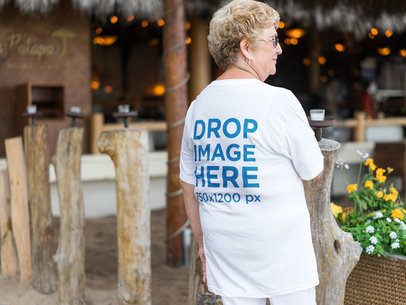 Back of an Elder Woman Wearing a T-Shirt Mockup while at the Beach
