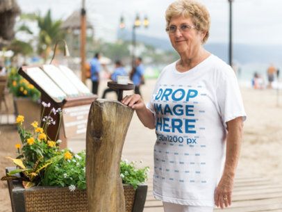 T-Shirt Mockup Featuring an Elder Woman at the Beach