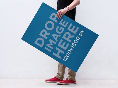 Poster Mockup of a Young Man Holding a Poster