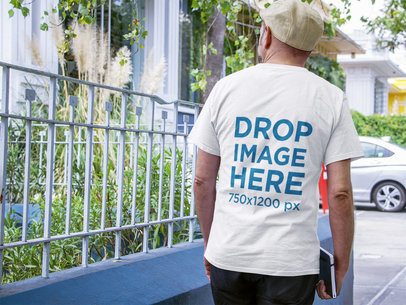 Man Wearing a Tshirt Mockup while Waiting for Someone on the Street