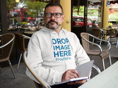 Middle Aged Man Wearing a Hoodie at a Cafe Mockup a10855
