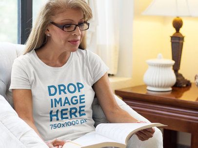 T-Shirt Mockup of a Middle-Aged Woman Reading in Her Home