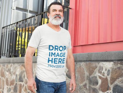 Mockup of an Elder Man Wearing a T-Shirt in an Urban Space
