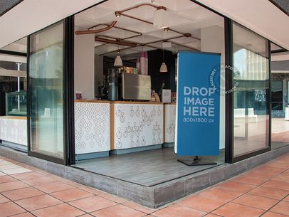 Roll-Up Banner Mockup at a Coffee Shop a11318