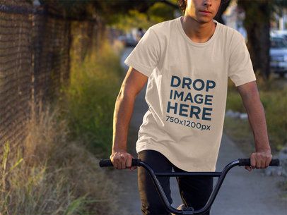 Tee Mockup of a Young Man Riding a Bike