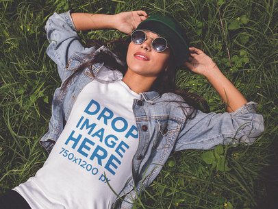 Mockup of a Trendy Woman Wearing a T-Shirt Lying in the Grass