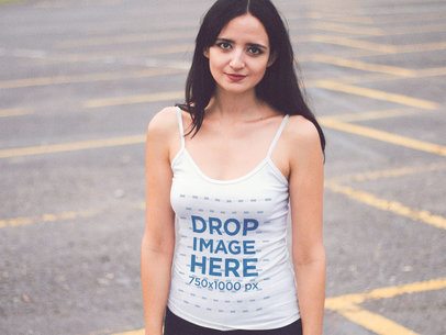 Mockup of a Pretty Woman Wearing a Scoop Neck Tank Top in a Parking Lot