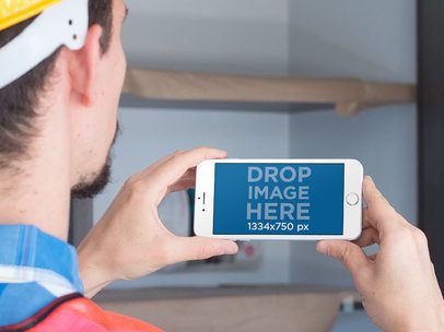 Over Shoulder Mockup of a Man Using an iPhone in Landscape Mode