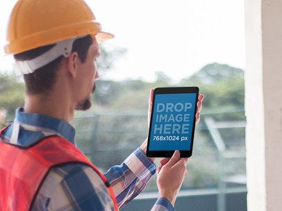 iPad Mockup in Portrait Mode of a Man Wearing a Construction Helmet