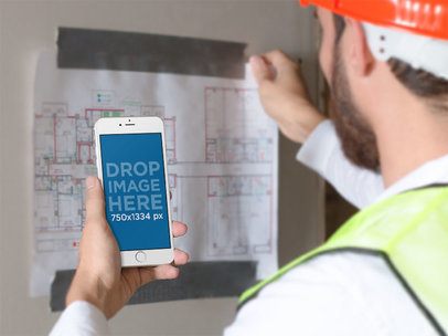 iPhone Mockup in Portrait Mode of a Man Looking at a Construction Plan 12425