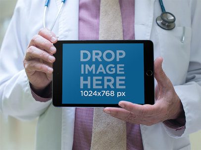 Mockup of a Physician Showing an iPad in Landscape Position
