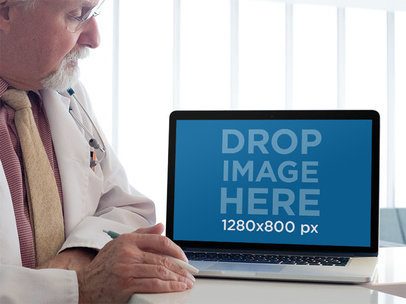 MacBook Mockup of a Senior Doctor Reviewing his Patient Information