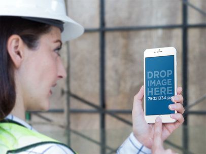 Mockup Featuring a Female Worker Staring at an iPhone in Portrait Position