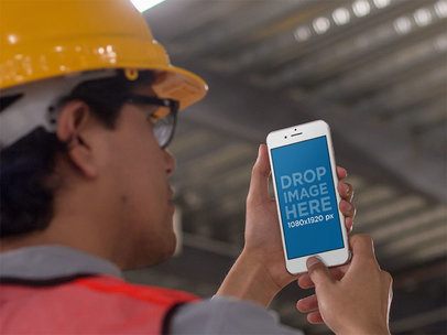 iPhone Mockup in Portrait Position Featuring a Man Inside a Factory 