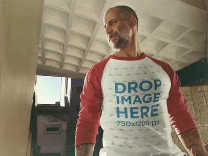 Raglan T-Shirt Mockup of a White Middle-Aged Man Standing Inside a City Building