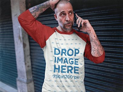 White Middle-Aged Man Wearing a Raglan Tee Mockup While Making a Phone Call on the Street