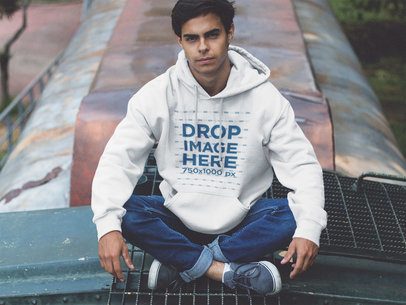 Young Man Sitting Cross-Legged on a Train Pullover Hoodie Mockup