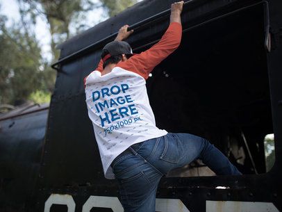 Back Side Raglan T-Shirt Mockup of a Guy Climbing on the Side of a Train a12480