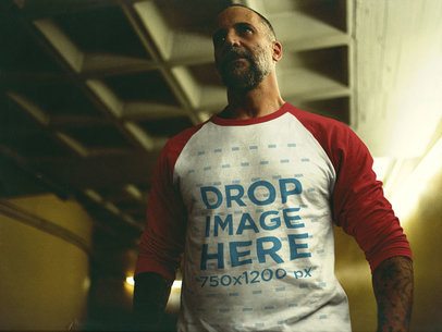 Serious Man Wearing a Raglan T-Shirt Inside a Dark City Parking Lot