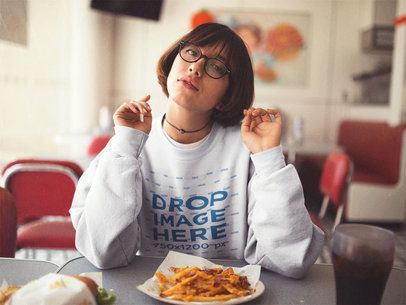 Crewneck Mockup of a Trendy Girl with Short Hair and Glasses Eating Fries at a Diner a12657