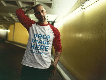 Tattooed Man Wearing a Raglan T-Shirt Mockup Walking Through a Parking Lot b12606