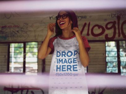 Raglan Tee Mockup of a Young Trendy Girl with a Beanie Laughing Inside an Abandoned Building a12482